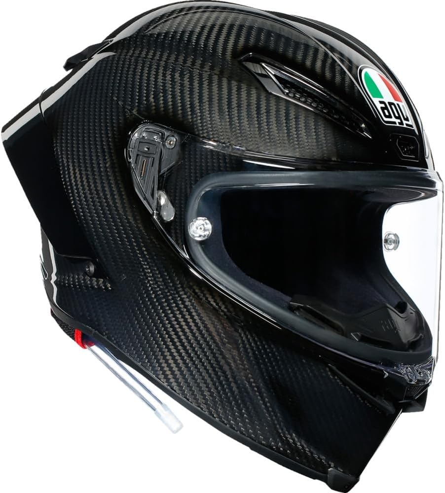 Close-up of an AGV Pista GP RR helmet in sleek carbon fiber finish, showcasing its aerodynamic design and transparent visor.