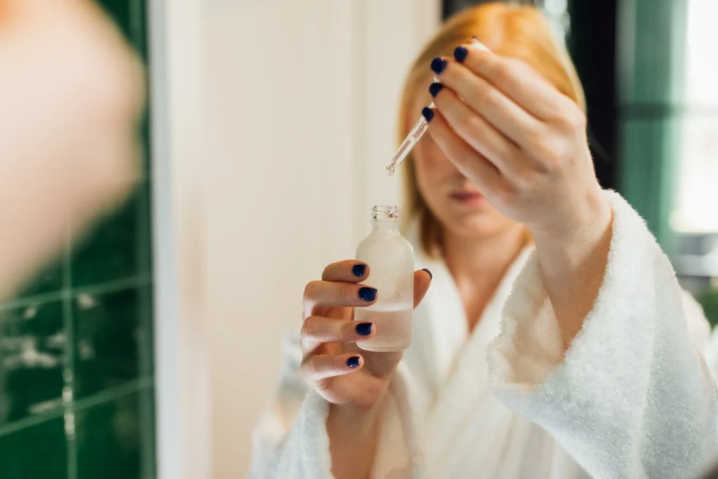 Woman applying bakuchiol serum as part of her daily skincare routine for smoother and radiant skin.