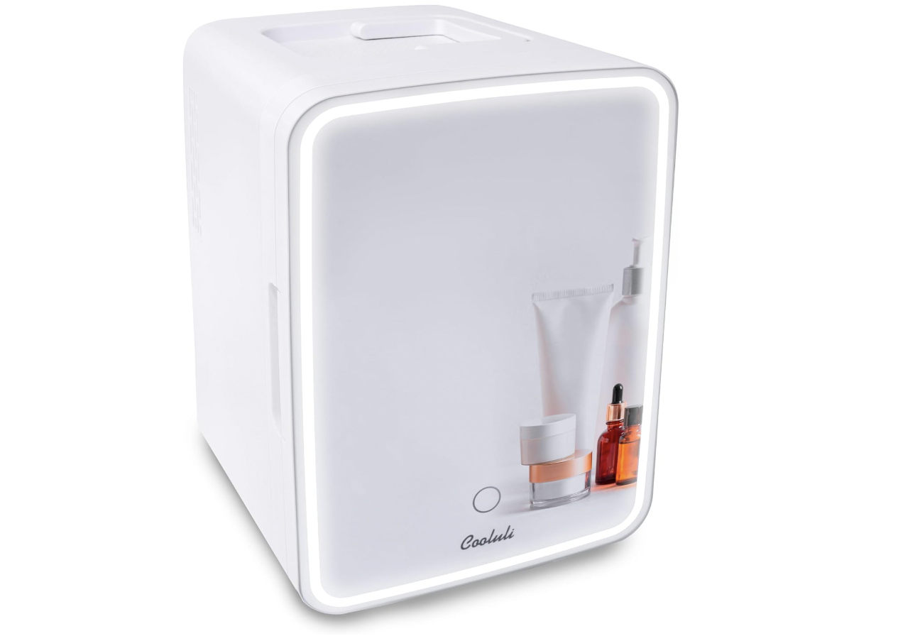A white Cooluli mini skincare fridge with a sleek mirrored door, LED lighting, and cosmetic products displayed on the front panel.
