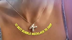 A woman wears a silver bubble letter “K” necklace on a delicate chain, with the text “10 Best Bubble Necklace to Shop” arched below in bold yellow font.