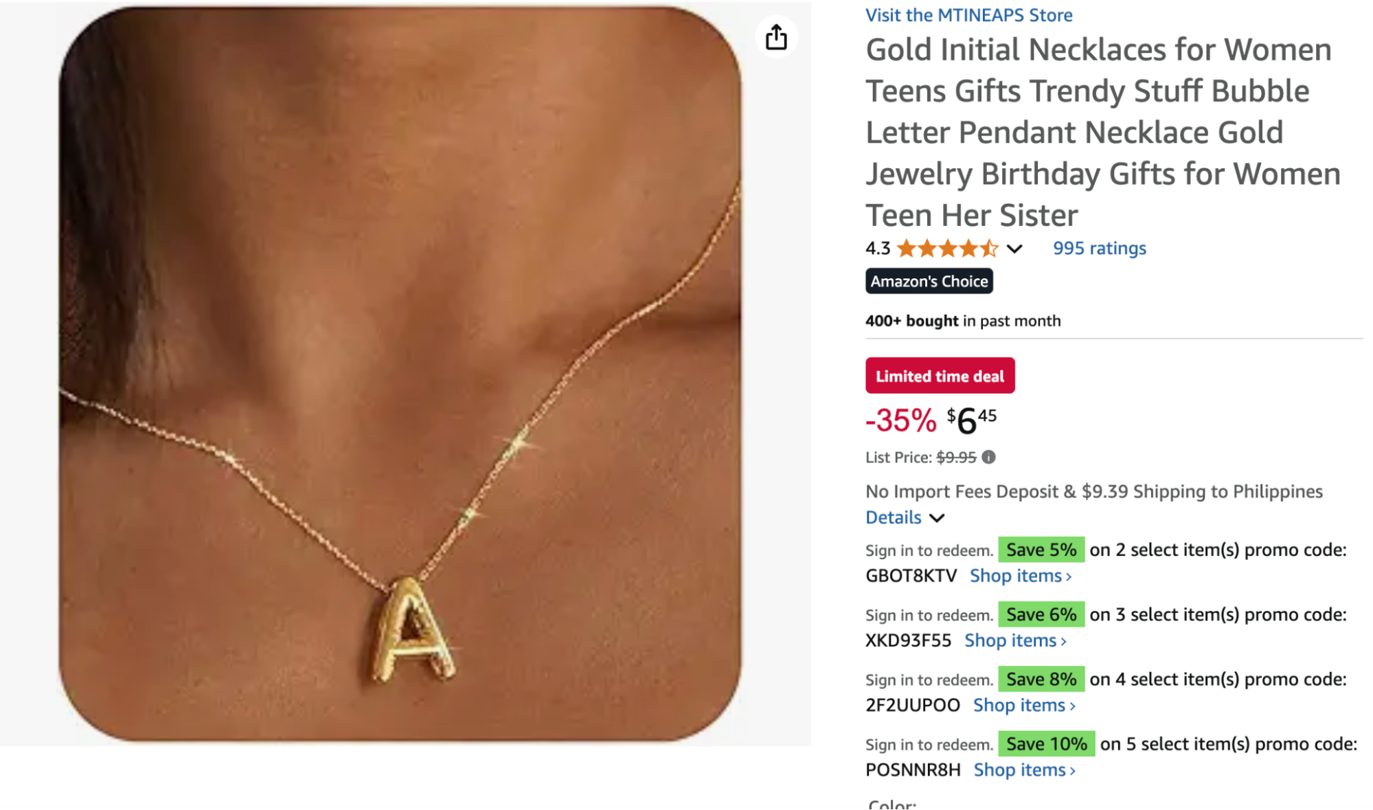 A gold bubble letter “A” necklace from MTINEAPS, shown worn on a model’s neck, featuring a delicate chain and shiny puffed pendant.
