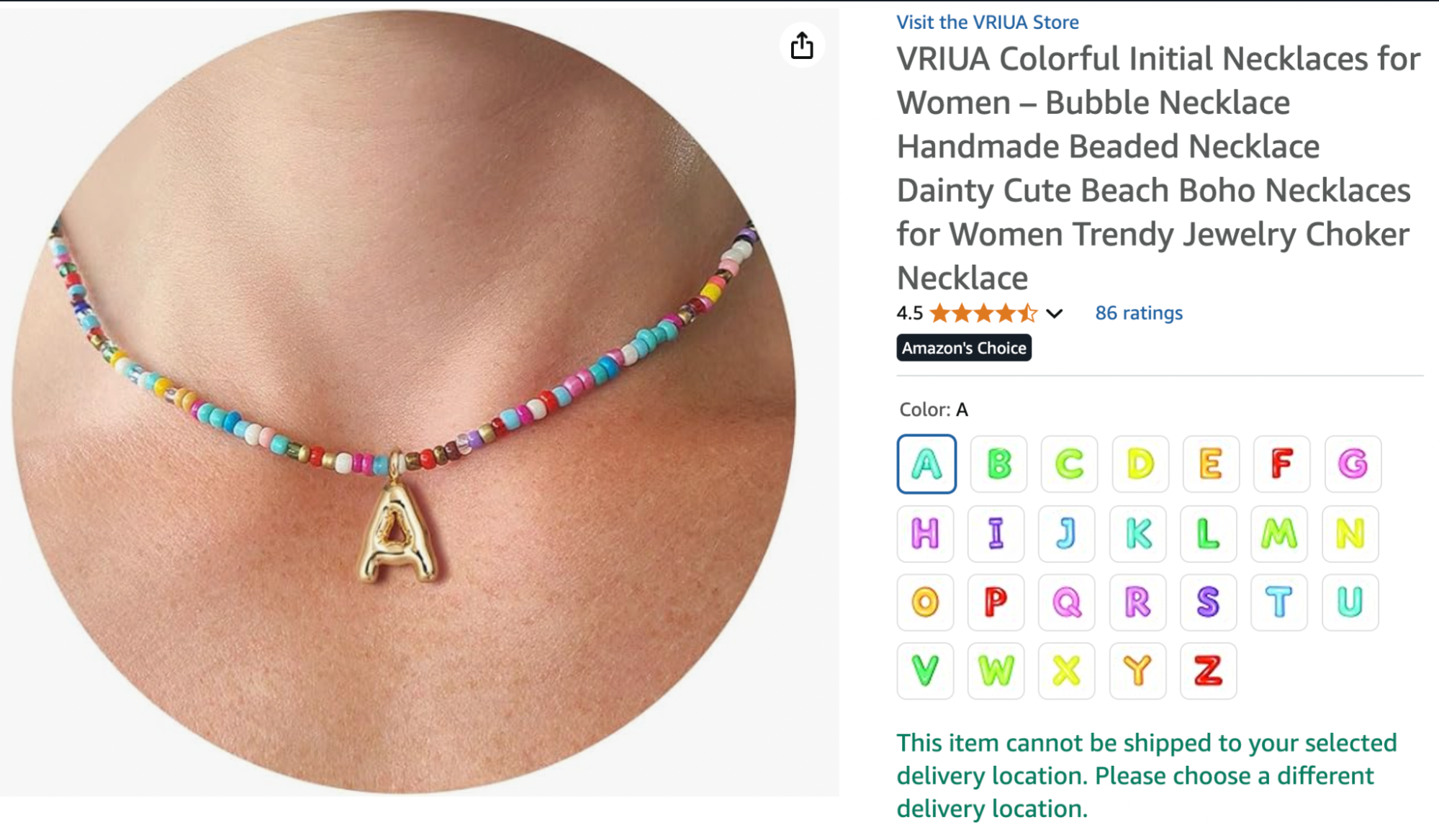 A handmade VRIUA beaded necklace featuring a colorful array of beads and a gold bubble letter “A” pendant, styled as a playful beachy choker.